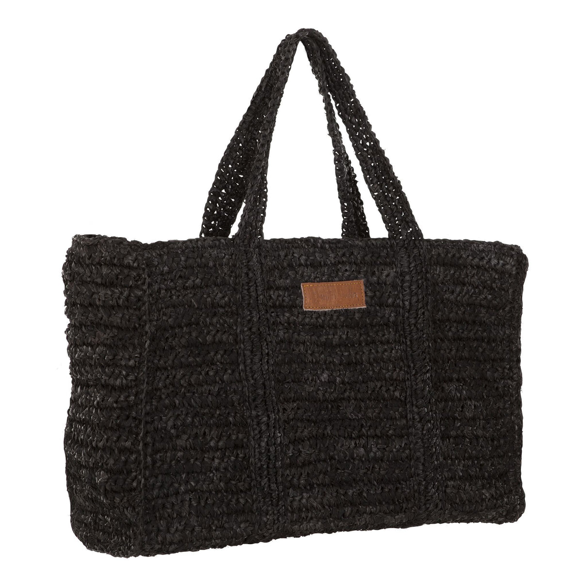 Shopper Saint-Tropez van MUST Living in zwart palmblad gestyled in een natuurlijk interieur