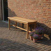 Bankje Teakhout Beige 120cm van Raw Materials, zijaanzicht met de massieve teakhouten poten