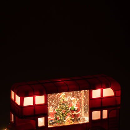 Kerstbus van J-Line met brandende ledverlichting in de ramen in een donkere kamer