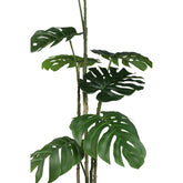 Groene kunstmonstera van PTMD van opzij met ingesneden bladeren