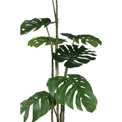 Groene kunstmonstera van PTMD van opzij met ingesneden bladeren