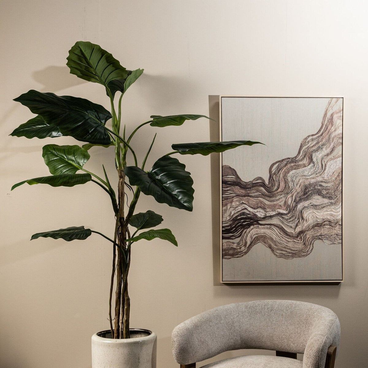 Grote kunstphilodendron van PTMD in zwarte pot in een lichte woonkamer