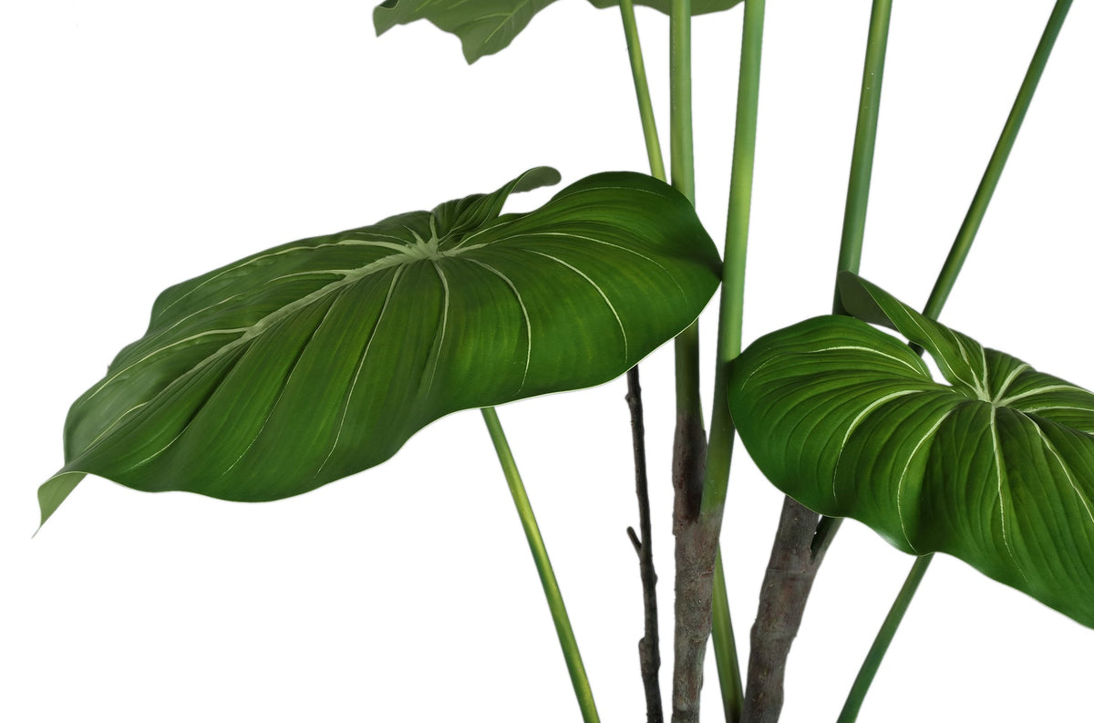 Groene kunstphilodendron van PTMD van opzij met brede uitwaaierende bladeren