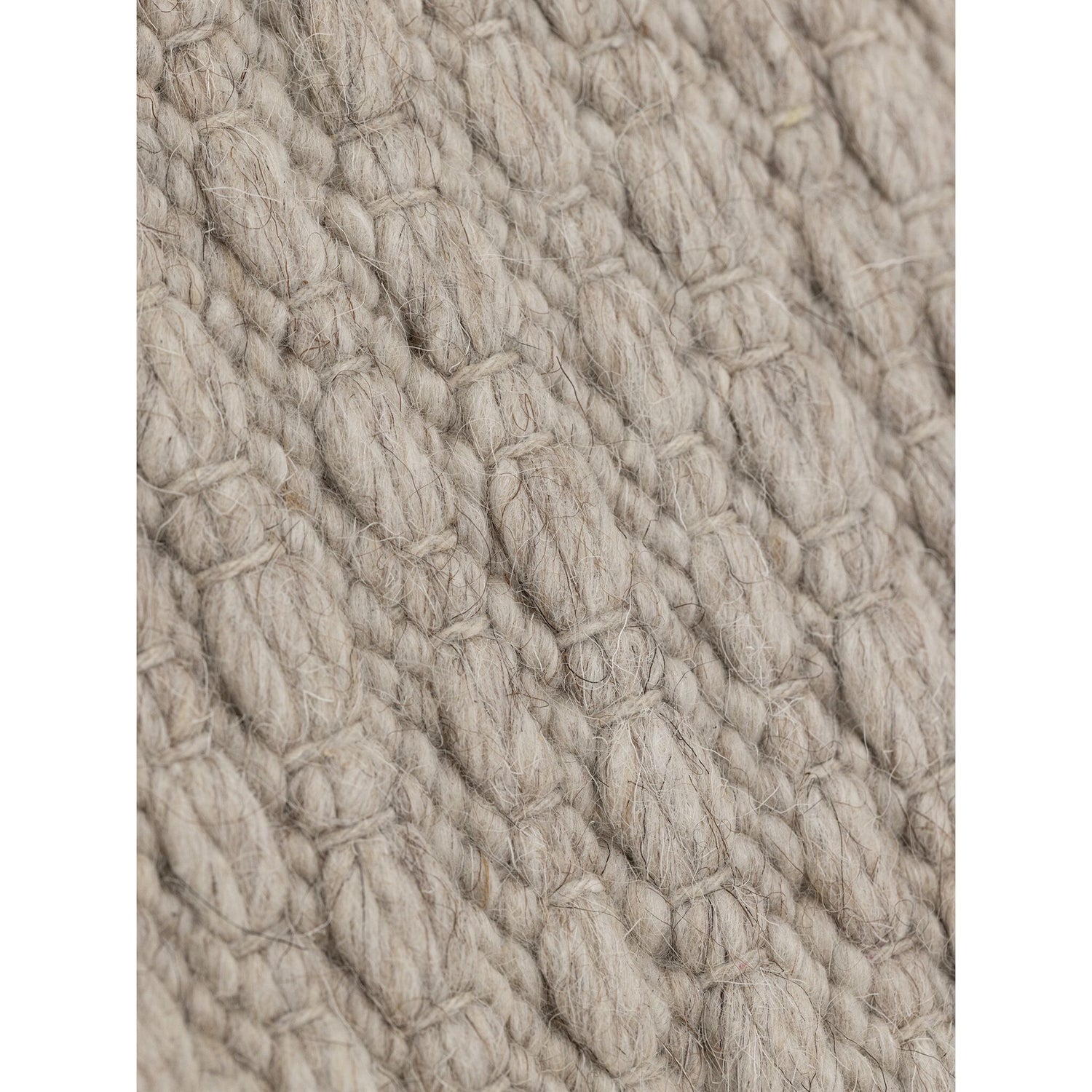 Nirvana vloerkleed van MUST Living in beige, detail van het gevlochten reliëfpatroon in de weving