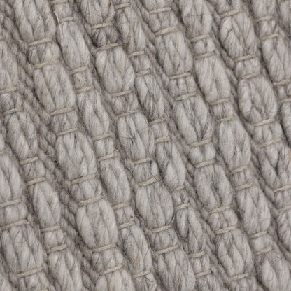 Detail van het grijze Nirvana vloerkleed van MUST Living met zichtbare wolvezels