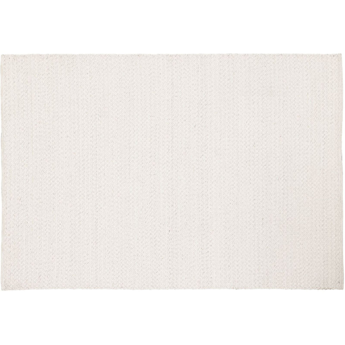Vloerkleed Nirvana Ivoor 170x240cm van MUST Living schuin van opzij gezien, met zicht op de zijkant en de afwerking