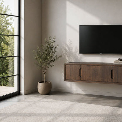 Zwevend Cortez tv-meubel aan de wand met televisie erboven en plant ernaast